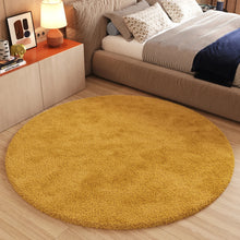 Load image into Gallery viewer, Round yellow rug on a wooden floor in a bedroom setting.