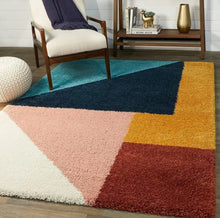 Load image into Gallery viewer, Colorful geometric-patterned rug in a room with a chair and small table.