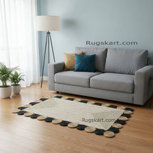 Load image into Gallery viewer, Living room with a gray sofa, decorative rug, and plants on a light blue wall background.