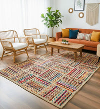Load image into Gallery viewer, Living room with a colorful patterned rug, orange sofa, and wooden coffee table.
