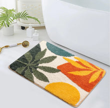 Load image into Gallery viewer, Colorful bath mat with leaf patterns on a bathroom floor.
