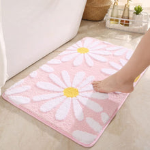 Load image into Gallery viewer, Pink floral rug with white flowers and yellow centers on a light-colored floor.
